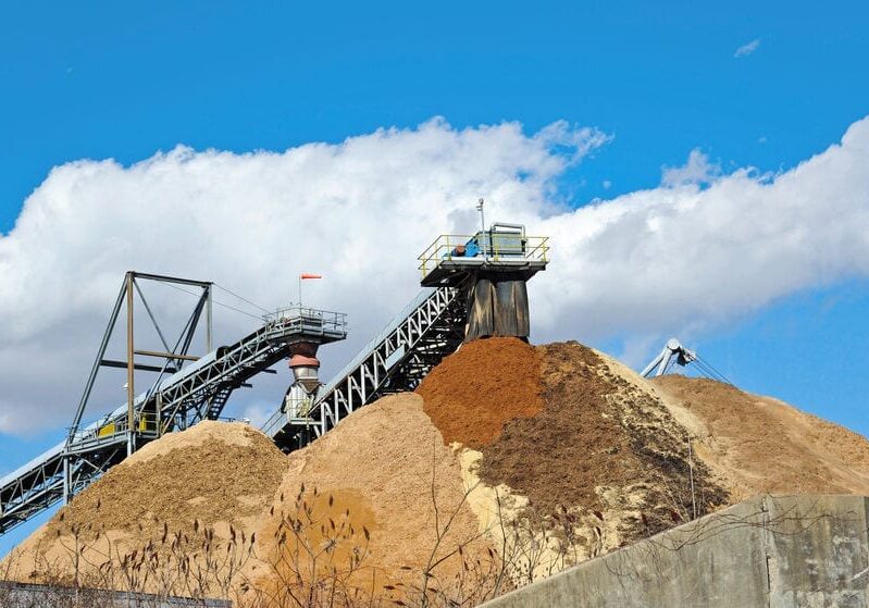 Conveyor Dumping Wood Chips and Biomass in a Pile at a Paper Mill