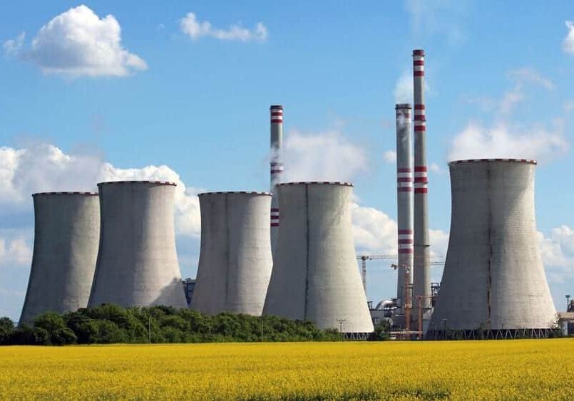 10973235 - view of coal power plant over yellow agriculture field